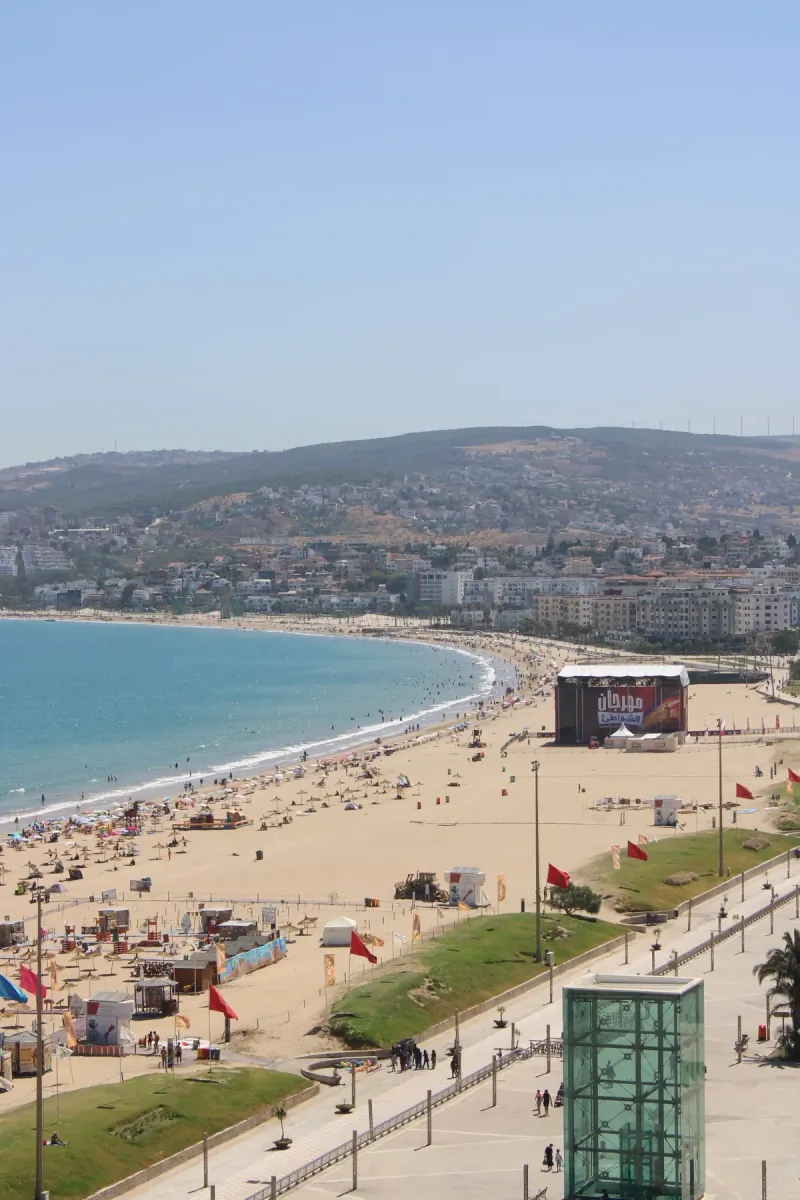 Wide sandy beach and calm Atlantic bay at Agadir, seen from the hillside with the city behind