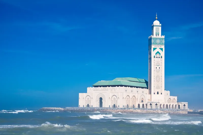 Hassan II Mosque and its tall minaret standing over the Atlantic surf in Casablanca