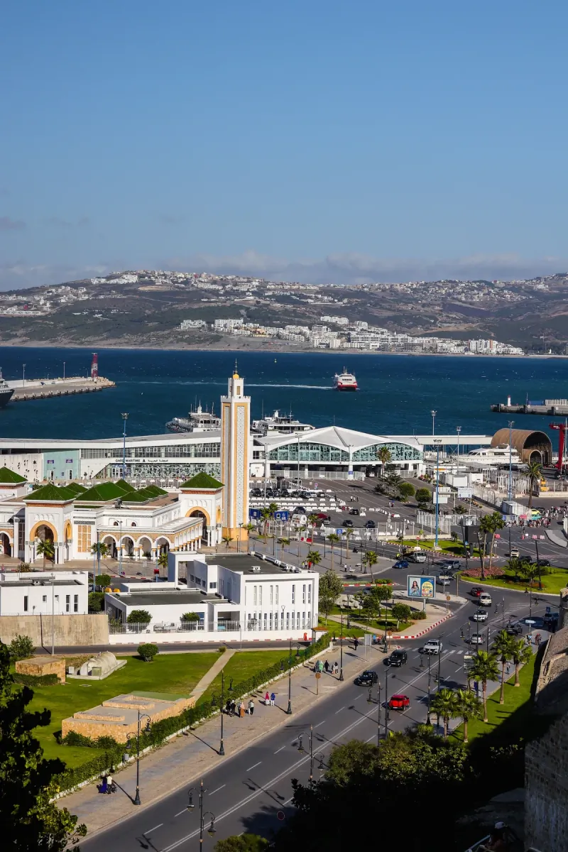 Tangier waterfront with the port mosque, palm-lined boulevard and the bay stretching to the headland